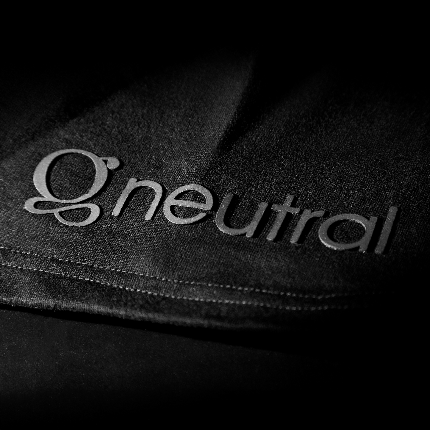 Black Oversized t-shirt - Defy the Noise , close-up of logo on left sleeve