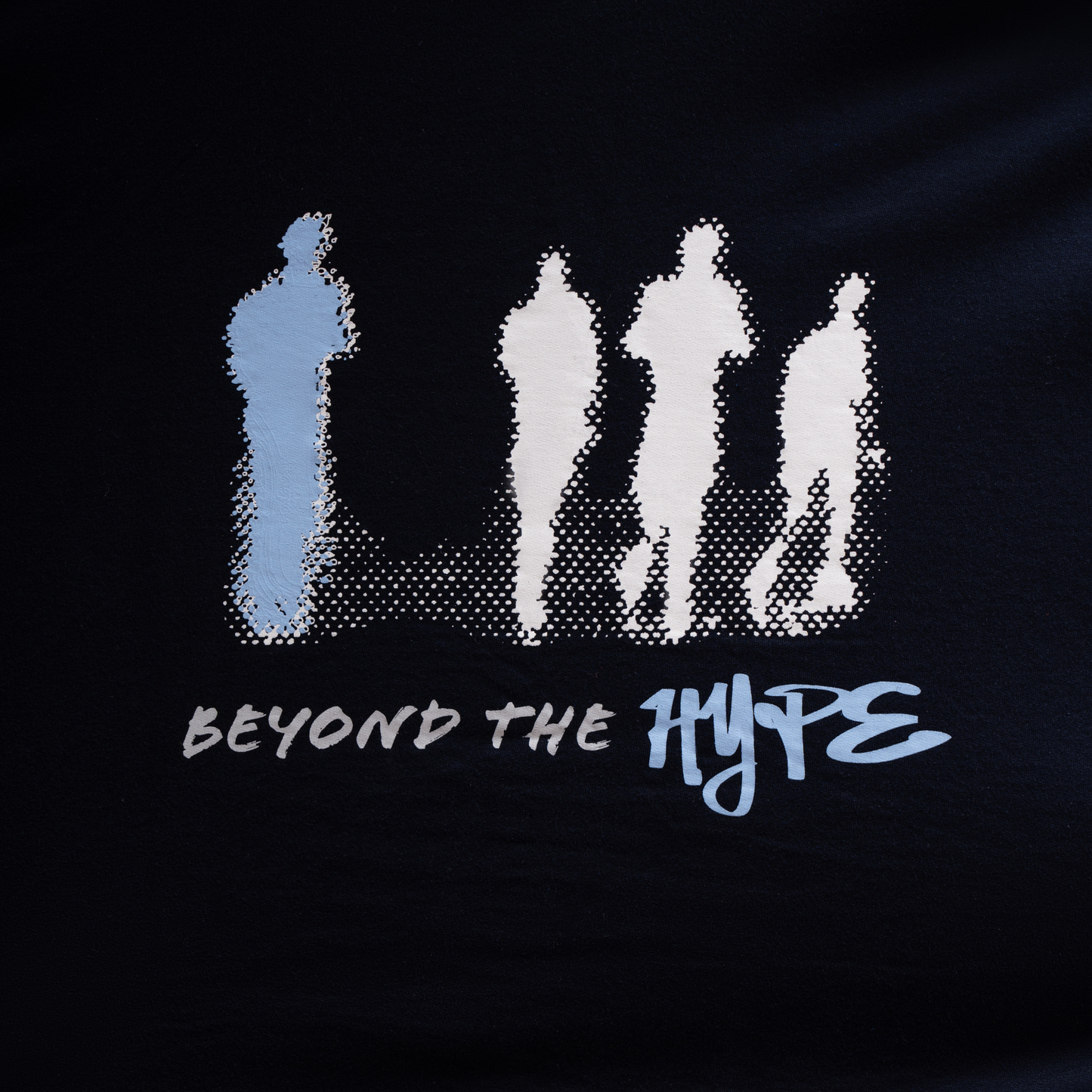 Navy Blue Oversized T-shirt - Solitary Pursuit , design featuring 4 figures where one is away from the others and a text saying "beyond the hype" below the design